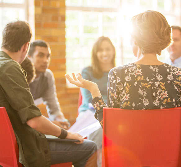 Group of colleagues in a sales meeting discussing sales performance.